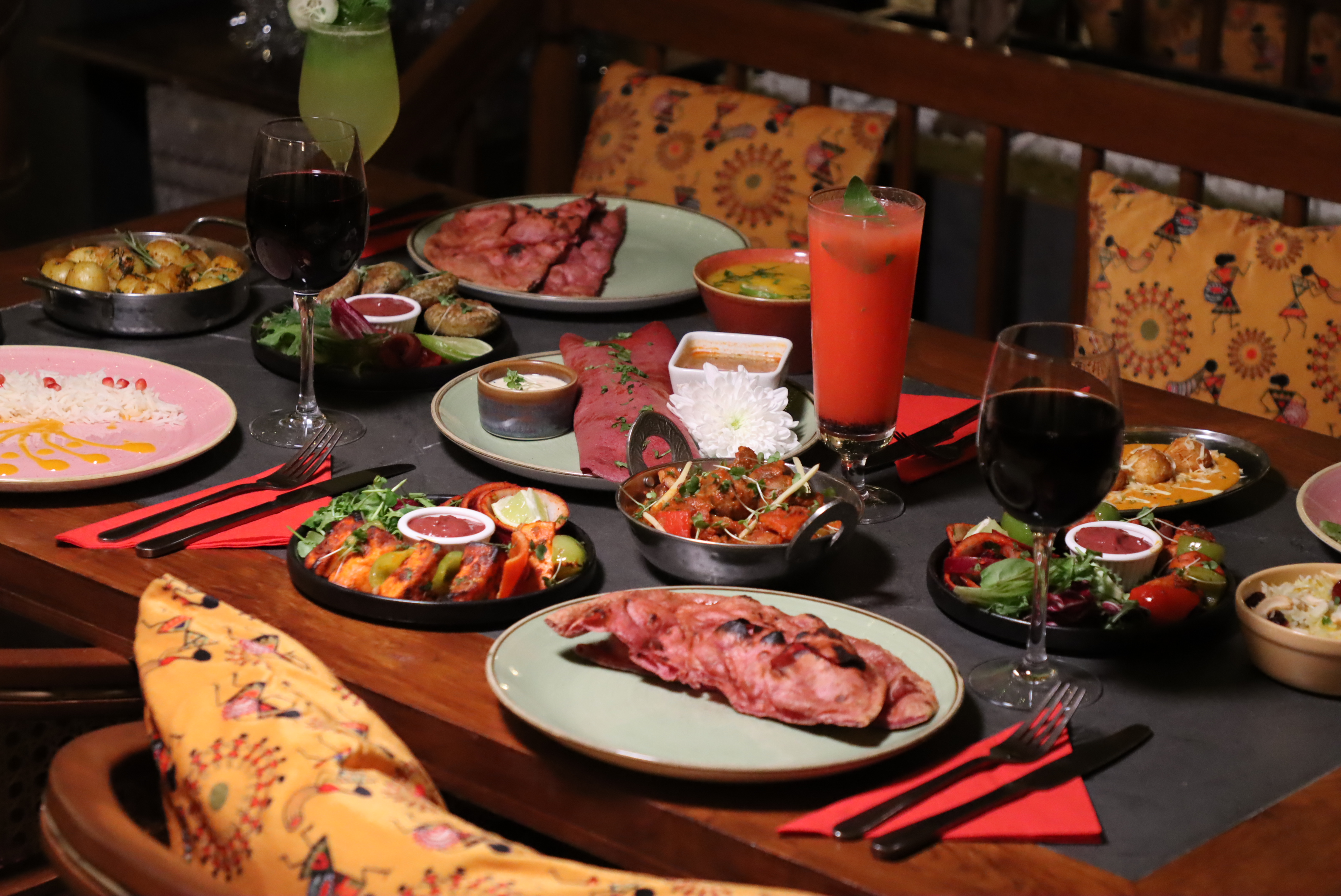 A shared table of Indian dishes at Namaste Village